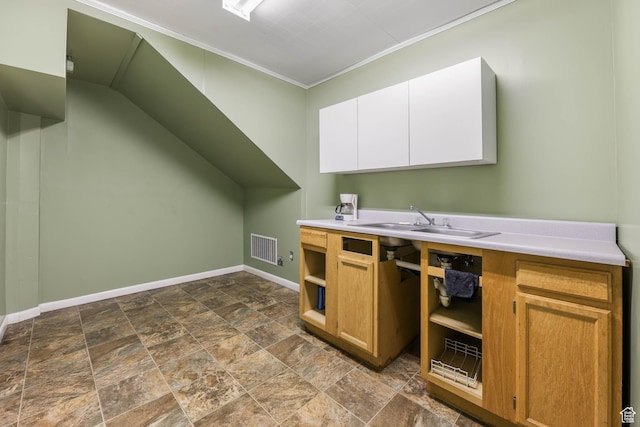 810 Canyon Rd, Ogden, UT 84404 - kitchen with ornamental molding, baseboards, dark stone finish flooring, a sink, and light countertops