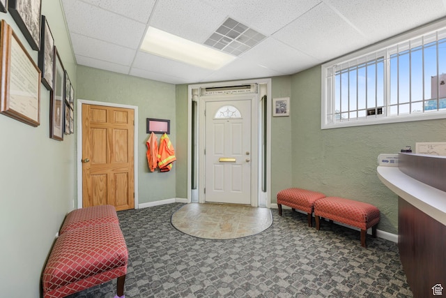 810 Canyon Rd, Ogden, UT 84404 - entryway featuring baseboards, tile patterned floors, a drop ceiling, and a textured wall