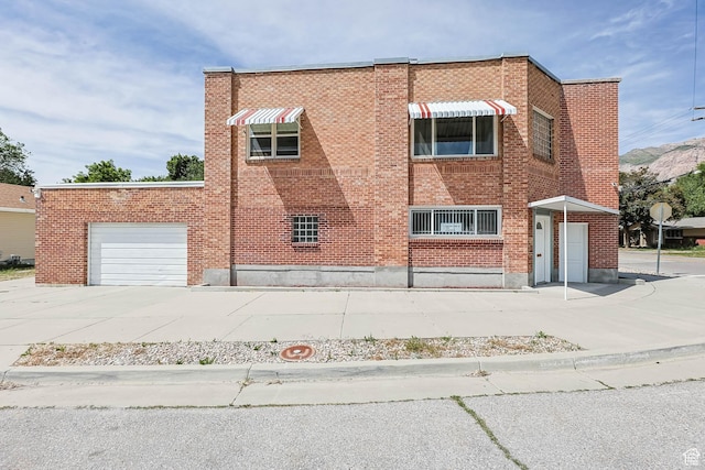 810 Canyon Rd, Ogden, UT 84404 - view of front of home with brick siding, concrete driveway, and an attached garage
