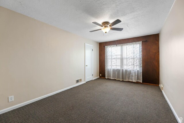 810 Canyon Rd, Ogden, UT 84404 - unfurnished room with a ceiling fan, baseboards, a textured ceiling, and dark carpet