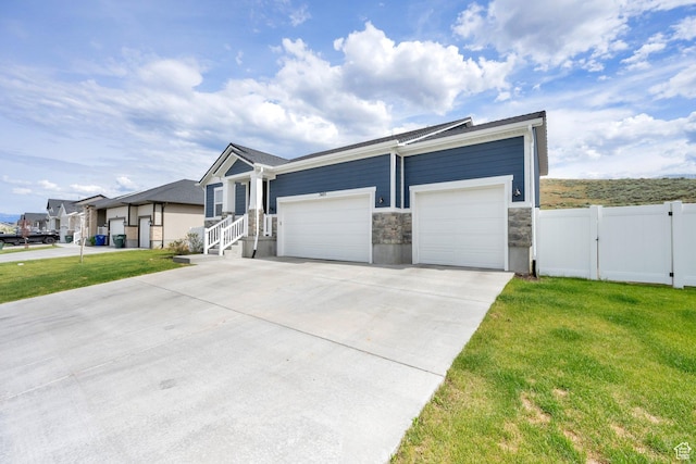 7405 W Glowing Sky Dr S, West Valley City, UT 84081 - ranch-style house with concrete driveway, a garage, a gate, and stone siding
