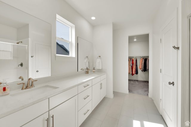 7405 W Glowing Sky Dr S, West Valley City, UT 84081 - bathroom with a shower stall, double vanity, a walk in closet, and recessed lighting