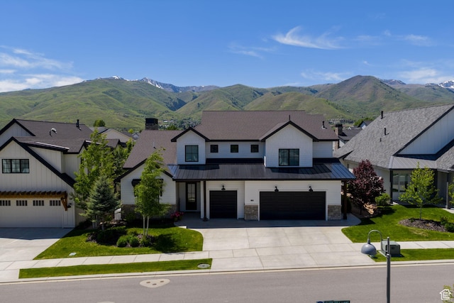 517 N Farm Hill Ln, Midway, UT 84049 - view of front of property with concrete driveway, a standing seam roof, an attached garage, and a mountain view