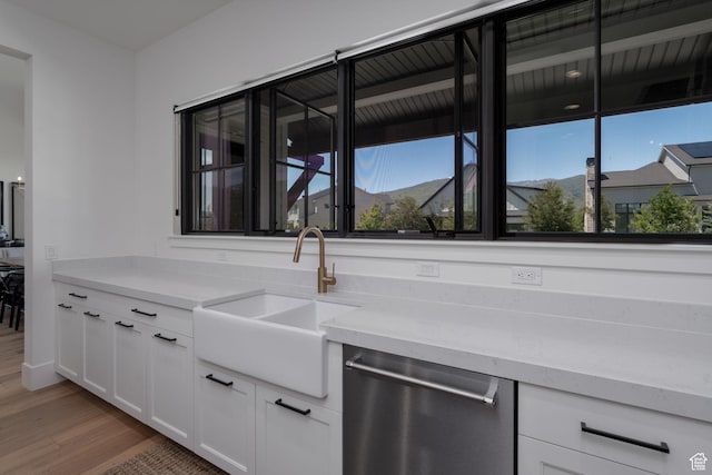 517 N Farm Hill Ln, Midway, UT 84049 - kitchen featuring stainless steel dishwasher, a sink, light wood-type flooring, and white cabinetry