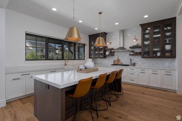 517 N Farm Hill Ln, Midway, UT 84049 - kitchen with wall chimney exhaust hood, light countertops, backsplash, glass insert cabinets, and recessed lighting