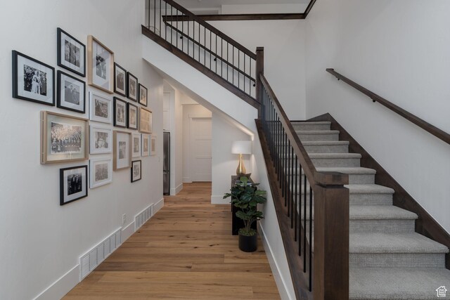 517 N Farm Hill Ln, Midway, UT 84049 - stairs with wood finished floors, baseboards, and a towering ceiling