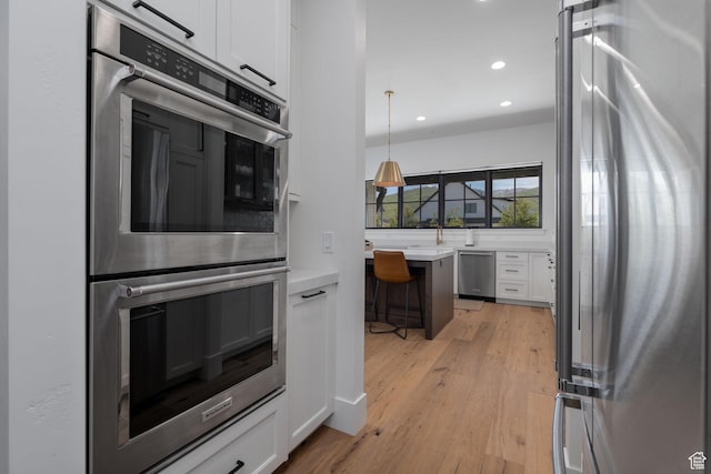 517 N Farm Hill Ln, Midway, UT 84049 - kitchen with stainless steel appliances, white cabinets, recessed lighting, light countertops, and light wood-style flooring