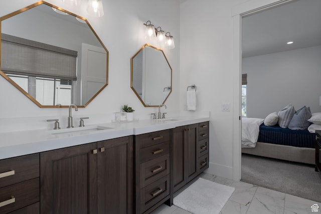 517 N Farm Hill Ln, Midway, UT 84049 - full bathroom with double vanity, marble look tiles, connected bathroom, and baseboards
