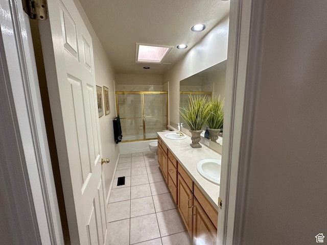 756 W 4375 S, Riverdale, UT 84405 - full bathroom with a skylight, double vanity, enclosed tub / shower combo, toilet, and tile patterned flooring