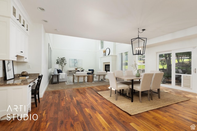 2188 E Tuscany Creek Way S, Draper, UT 84020 - dining area with dark wood-type flooring, a glass covered fireplace, and a chandelier