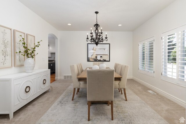 2188 E Tuscany Creek Way S, Draper, UT 84020 - dining room with light carpet, arched walkways, a chandelier, baseboards, and recessed lighting