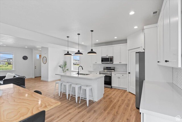 732 W 800 S, Springville, UT 84663 - kitchen with stainless steel appliances, tasteful backsplash, a sink, a kitchen bar, and white cabinetry