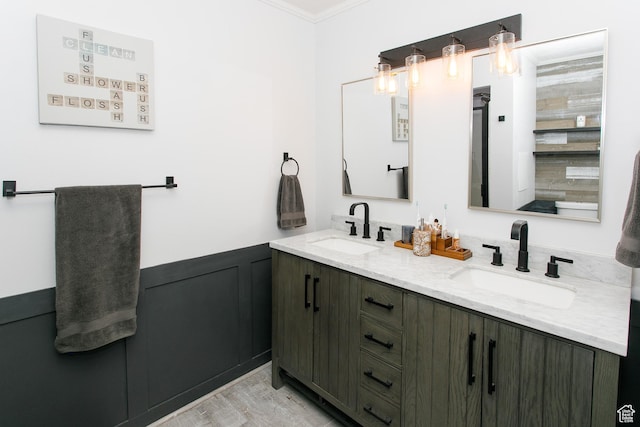 1062 Creek View Dr, Fruit Heights, UT 84037 - bathroom featuring double vanity, crown molding, wainscoting, and wood finished floors