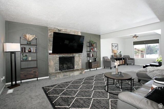 1062 Creek View Dr, Fruit Heights, UT 84037 - carpeted living area featuring baseboards, a stone fireplace, and a textured ceiling