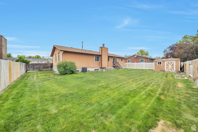 5373 S Clover Meadow Dr W, Murray, UT 84123 - rear view of property with a chimney, entry steps, and central AC