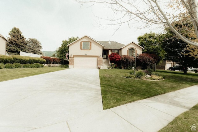 3234 N 550 W, Pleasant View, UT 84414 - view of front of home featuring concrete driveway, a garage, and a front lawn