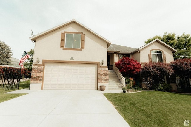 3234 N 550 W, Pleasant View, UT 84414 - view of front of house featuring driveway, brick siding, a garage, and stucco siding