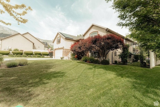 3234 N 550 W, Pleasant View, UT 84414 - view of front of house featuring roof mounted solar panels, an attached garage, stucco siding, and concrete driveway