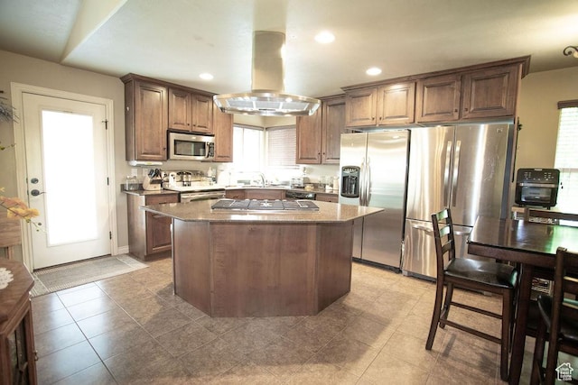 3234 N 550 W, Pleasant View, UT 84414 - kitchen with appliances with stainless steel finishes, island range hood, a kitchen island, recessed lighting, and light stone counters