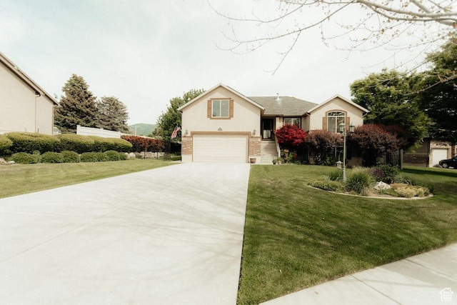 3234 N 550 W, Pleasant View, UT 84414 - view of front of home with driveway, a garage, and a front lawn