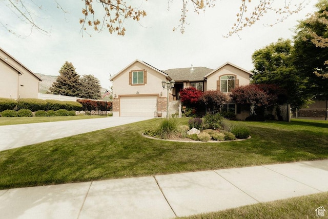 3234 N 550 W, Pleasant View, UT 84414 - view of front of home featuring an attached garage, driveway, and a front lawn