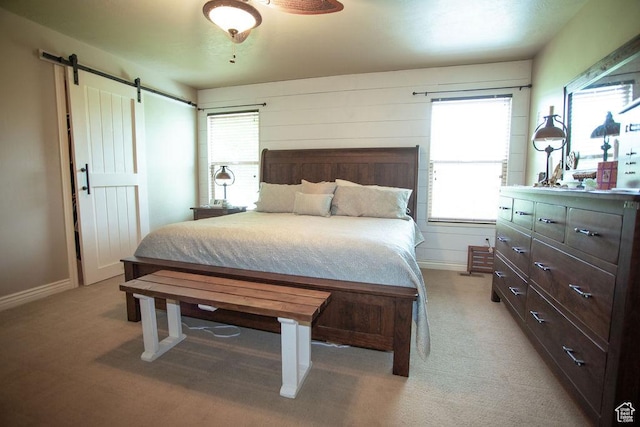 3234 N 550 W, Pleasant View, UT 84414 - bedroom featuring a barn door, light colored carpet, and baseboards