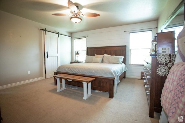 3234 N 550 W, Pleasant View, UT 84414 - bedroom featuring a barn door, light carpet, ceiling fan, and baseboards