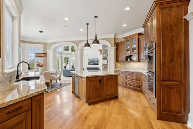 870 E Quail Hollow Cir, Alpine, UT 84004 - kitchen featuring a sink, ornate columns, brown cabinetry, glass insert cabinets, and light wood finished floors