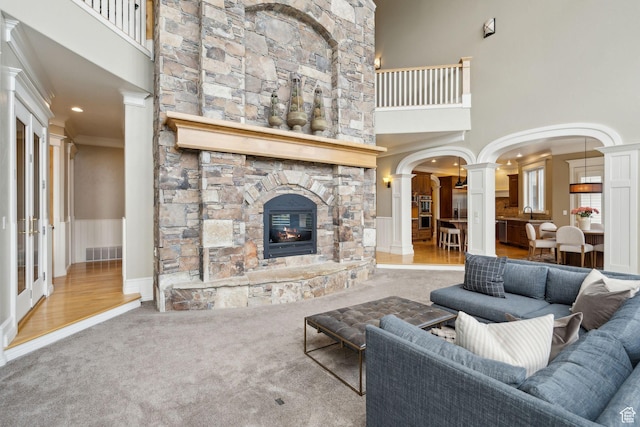 870 E Quail Hollow Cir, Alpine, UT 84004 - living area with ornate columns, carpet, a towering ceiling, a stone fireplace, and crown molding