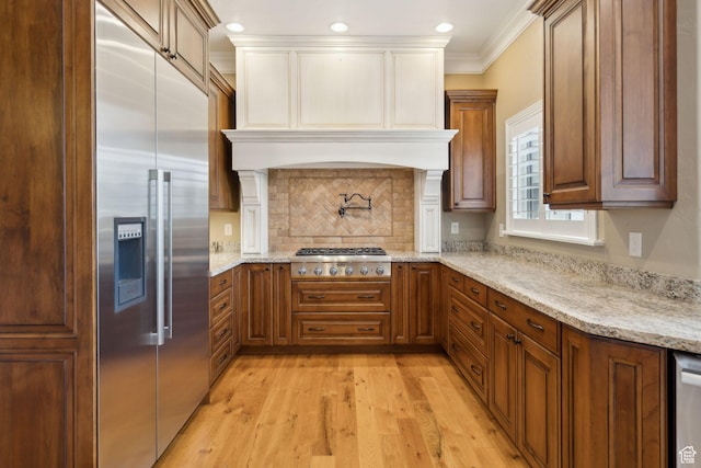 870 E Quail Hollow Cir, Alpine, UT 84004 - kitchen with stainless steel appliances, light wood-type flooring, ornamental molding, tasteful backsplash, and light stone countertops