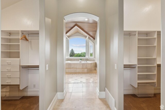 870 E Quail Hollow Cir, Alpine, UT 84004 - walk in closet featuring arched walkways, tile patterned flooring, and lofted ceiling