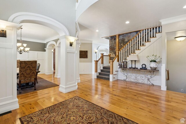 870 E Quail Hollow Cir, Alpine, UT 84004 - entryway with a decorative wall, ornate columns, arched walkways, stairway, and light wood-style flooring