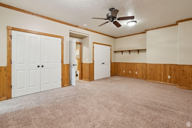 870 E Quail Hollow Cir, Alpine, UT 84004 - unfurnished bedroom featuring wainscoting, two closets, wooden walls, carpet flooring, and ornamental molding