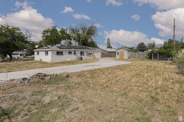 4815 W 4895 S, Kearns, UT 84118 - rear view of property featuring solar panels, central air condition unit, and concrete driveway