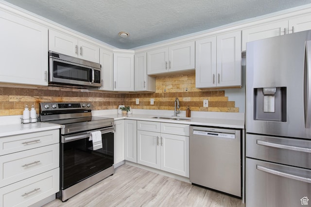 4815 W 4895 S, Kearns, UT 84118 - kitchen featuring appliances with stainless steel finishes, a sink, light countertops, decorative backsplash, and a textured ceiling