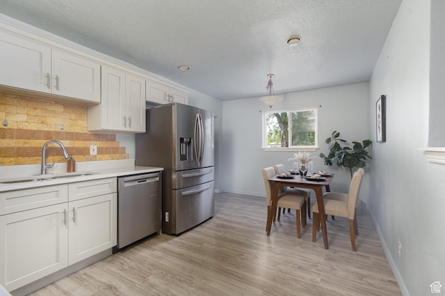 4815 W 4895 S, Kearns, UT 84118 - kitchen with appliances with stainless steel finishes, a sink, decorative backsplash, baseboards, and light countertops
