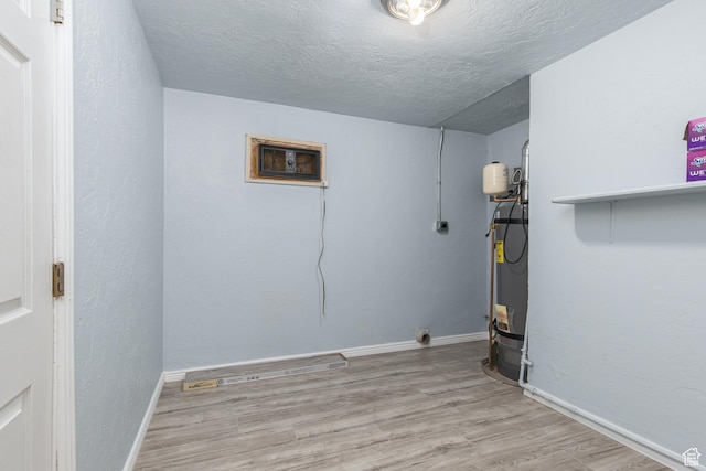 4815 W 4895 S, Kearns, UT 84118 - laundry room featuring wood finished floors, a textured ceiling, an AC wall unit, water heater, and baseboards