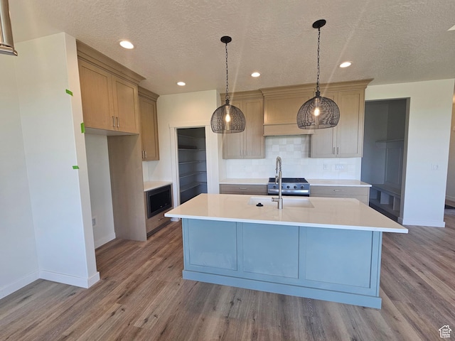 3197 N 2875 W Unit 35, Plain City, UT 84404 - kitchen featuring black microwave, light countertops, wood finished floors, decorative backsplash, and recessed lighting