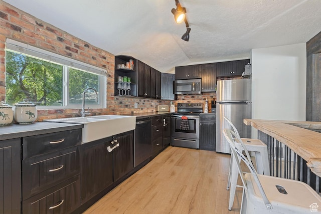 1250 E Center St, Springville, UT 84663 - kitchen featuring stainless steel appliances, light wood finished floors, a sink, open shelves, and brick wall