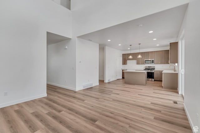 6737 S Glade Creek Dr W Unit 226, West Jordan, UT 84081 - unfurnished living room with light wood finished floors and recessed lighting