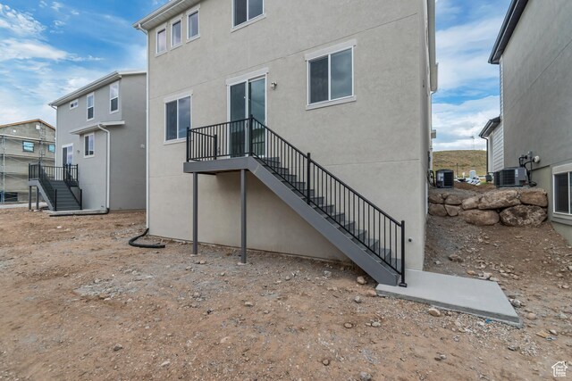 6737 S Glade Creek Dr W Unit 226, West Jordan, UT 84081 - rear view of property with stairway and stucco siding