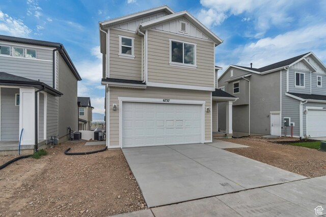 6737 S Glade Creek Dr W Unit 226, West Jordan, UT 84081 - view of front of home with board and batten siding, a garage, and driveway
