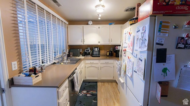 966 Mckinley Ave Unit B, Pocatello, ID 83201 - kitchen with freestanding refrigerator, stainless steel dishwasher, light wood-type flooring, and white cabinetry