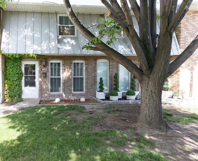 966 Mckinley Ave Unit B, Pocatello, ID 83201 - view of front of house featuring board and batten siding, a front yard, and brick siding