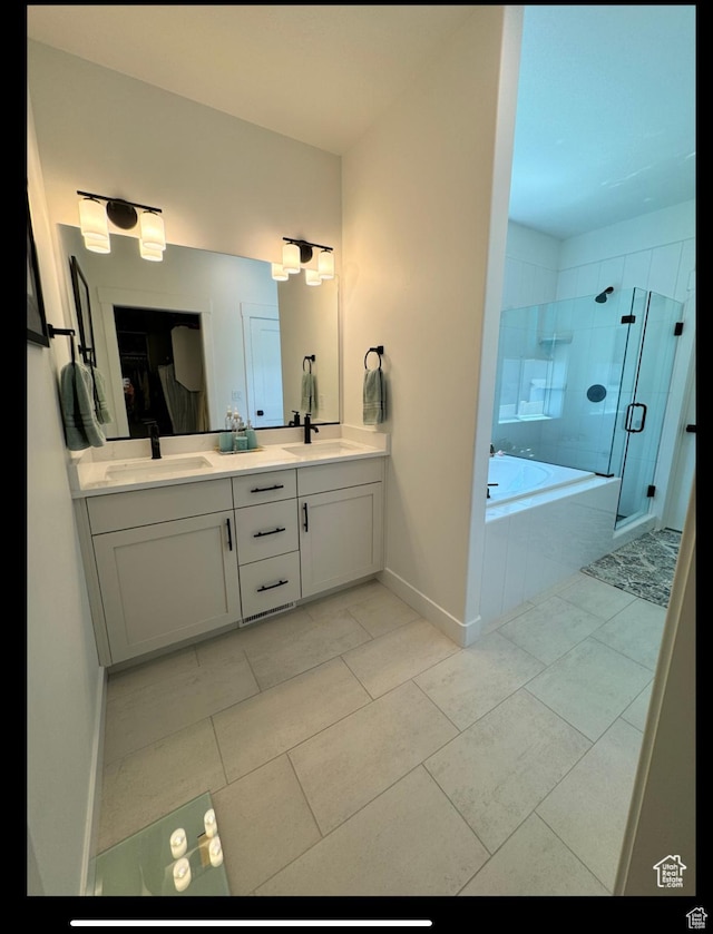 653 S 340 E, Smithfield, UT 84335 - full bathroom featuring double vanity, a stall shower, a garden tub, baseboards, and tile patterned flooring