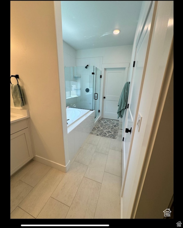 653 S 340 E, Smithfield, UT 84335 - bathroom featuring a stall shower, a bath, vanity, tile patterned flooring, and recessed lighting
