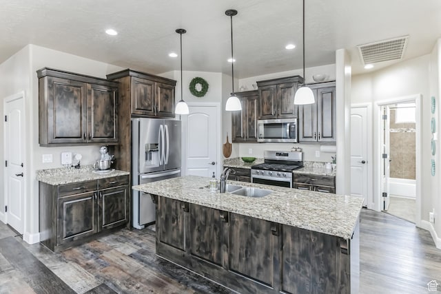 533 N Creek Ridge Cir, Washington, UT 84780 - kitchen with appliances with stainless steel finishes, a sink, dark brown cabinets, dark wood-type flooring, and recessed lighting