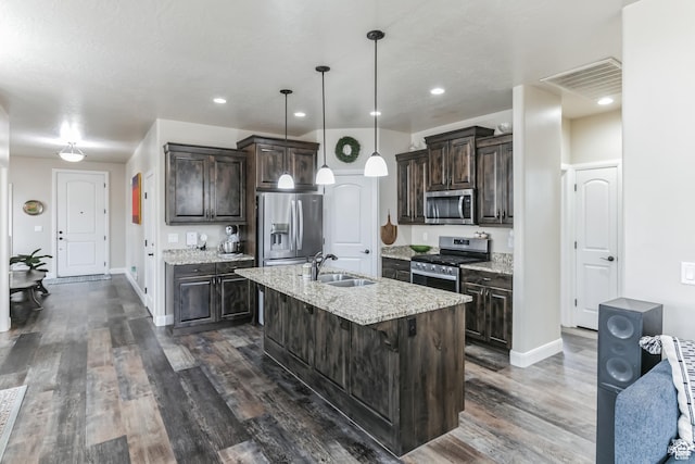 533 N Creek Ridge Cir, Washington, UT 84780 - kitchen with stainless steel appliances, dark brown cabinetry, baseboards, a sink, and recessed lighting
