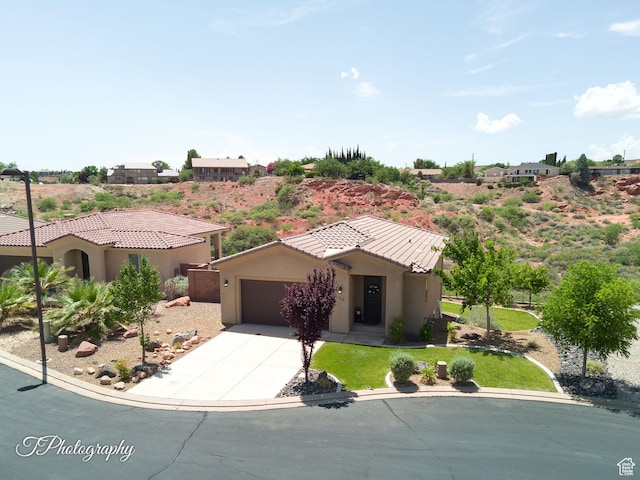 533 N Creek Ridge Cir, Washington, UT 84780 - view of front of home featuring driveway, stucco siding, a garage, and a tile roof