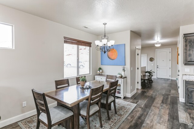 533 N Creek Ridge Cir, Washington, UT 84780 - dining area featuring a chandelier, dark wood-style floors, and baseboards